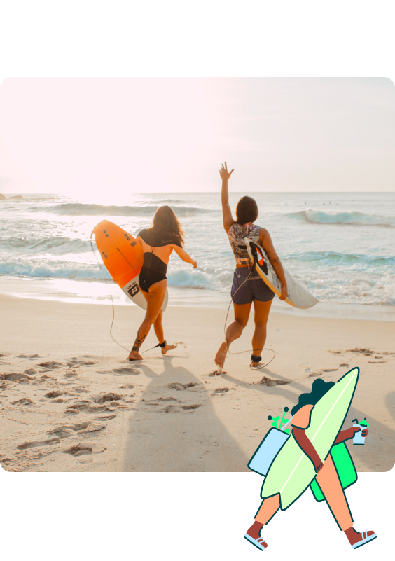 Two women walking towards the oceans carrying surfboards